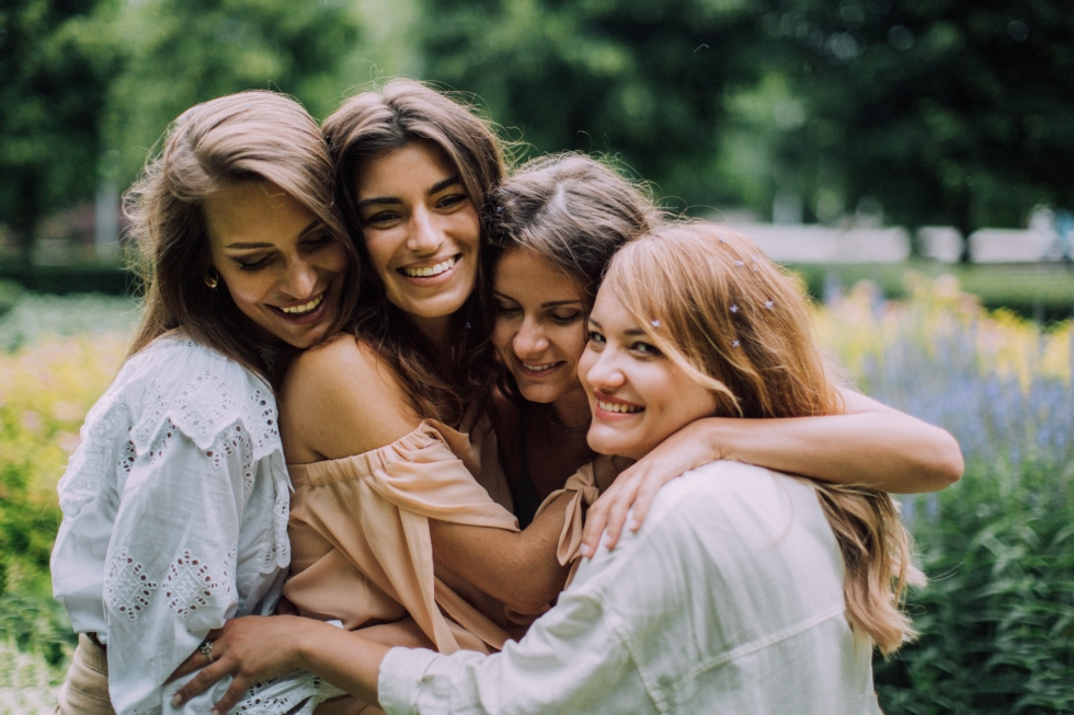 qui inviter à mon evjf : 4 copines qui se prennnent dans les bras dans un jardin 