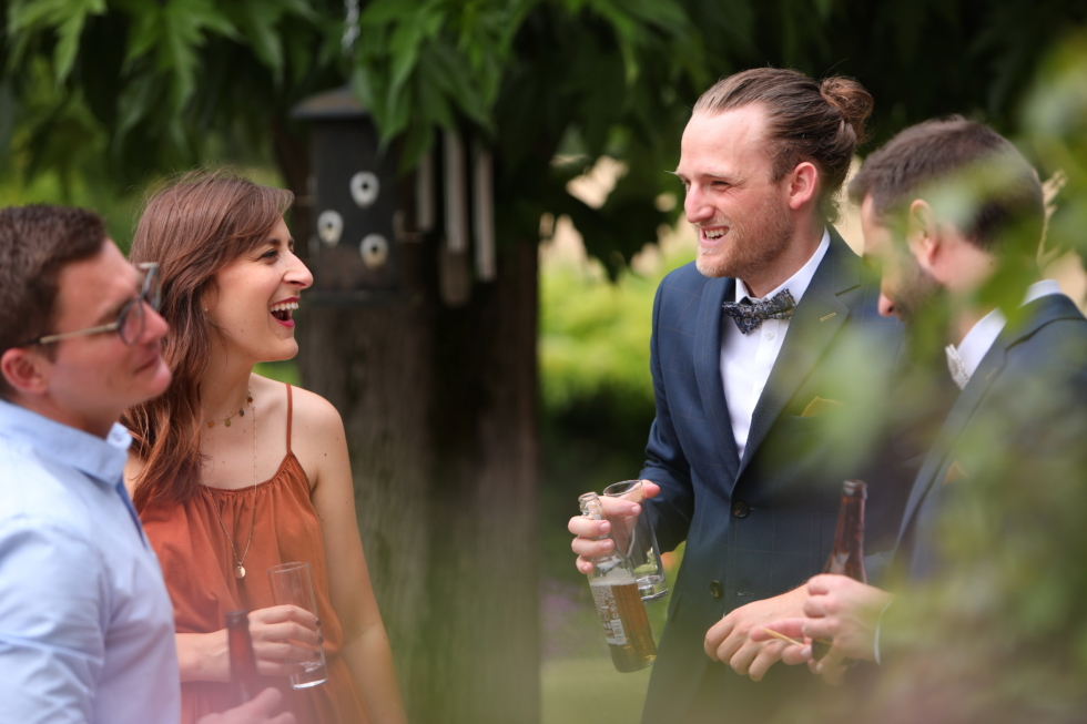L'organisation totale de votre mariage les invités discutant avec une bière à la main
